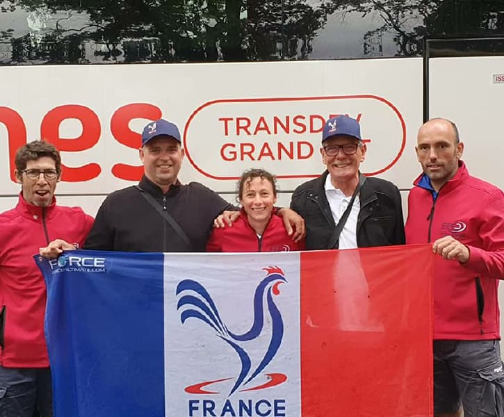 entraineurs de France portant une softshell rouge tenant un drapeau français