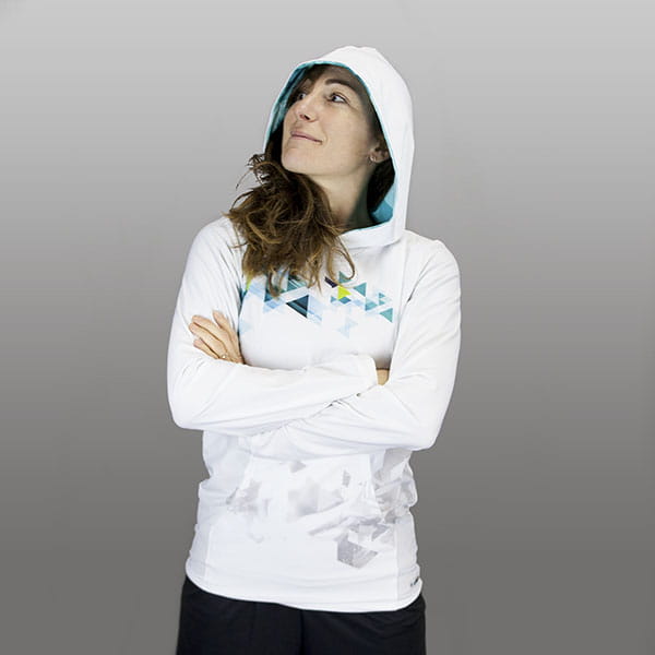 woman wearing a white hoodie crossing arms