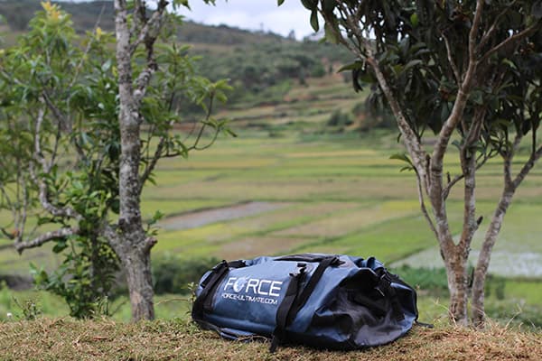 duffle bag on ground in nature scenery