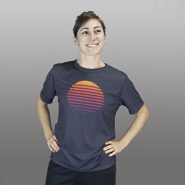 woman wearing a dark grey sublimated t-shirt with a sunset
