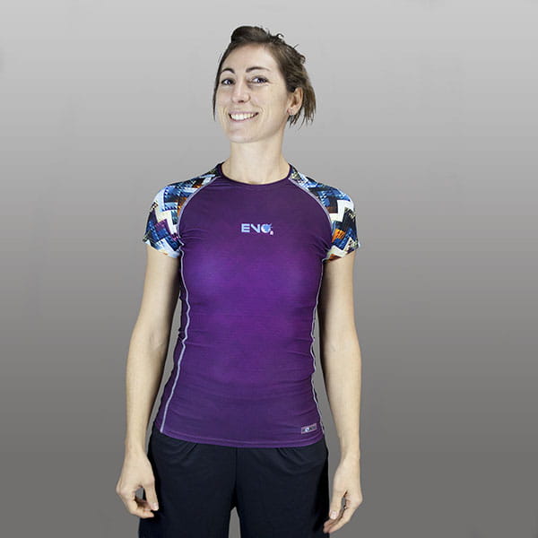 woman smiling wearing a purple compression top