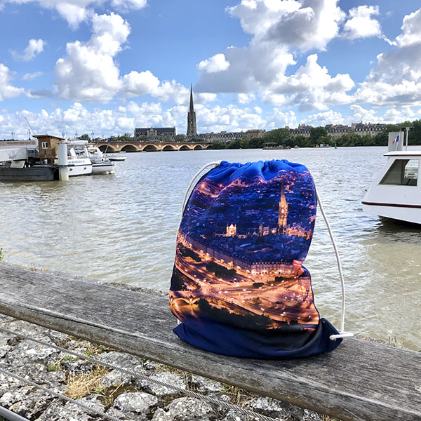 sublimated drawstring bag showing bordeaux by night on the shore of the garonne river
