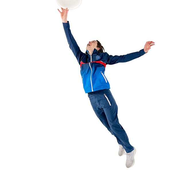 woman jumping and catching a disc wearing fully sublimated blue jacket and trousers
