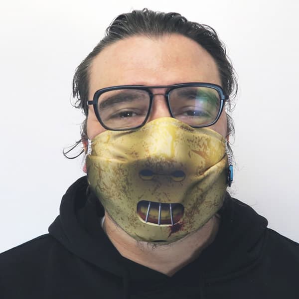 man with glasses wearing a hannibal lecter facemask