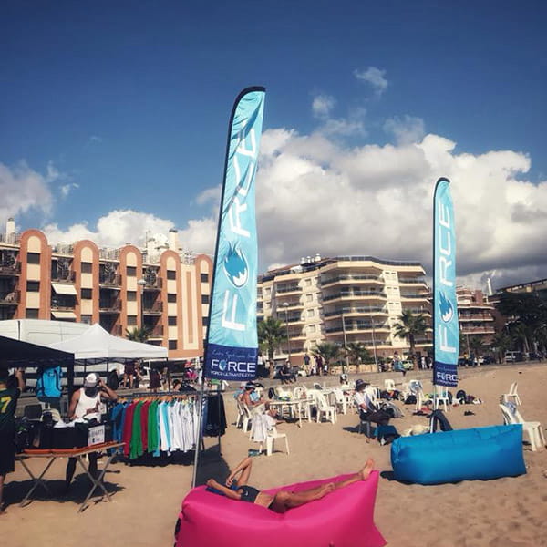 stand shop on beach with blue beach flags