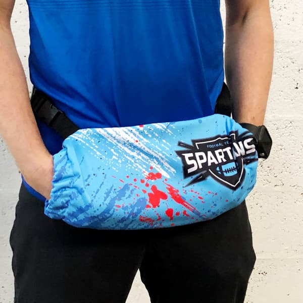 torso of a man wearing a blue handwarmer with his hands inside