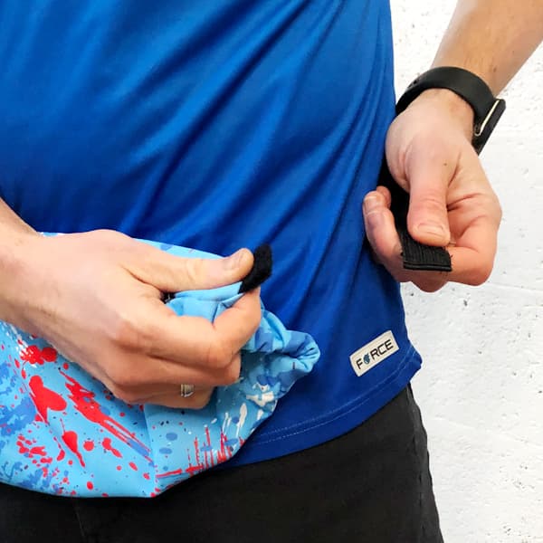 torso of a man wearing a blue handwarmer with strap released