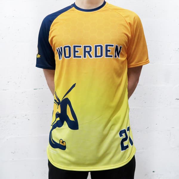 man wearing a yellow gradient and blue raglan sport jersey with woerden writing
