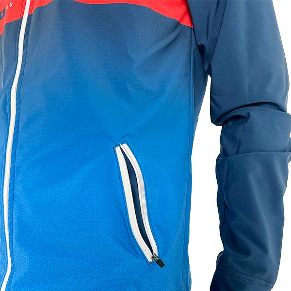 half torso of a person wearing a sublimated blue jacket with a zipped pocket open