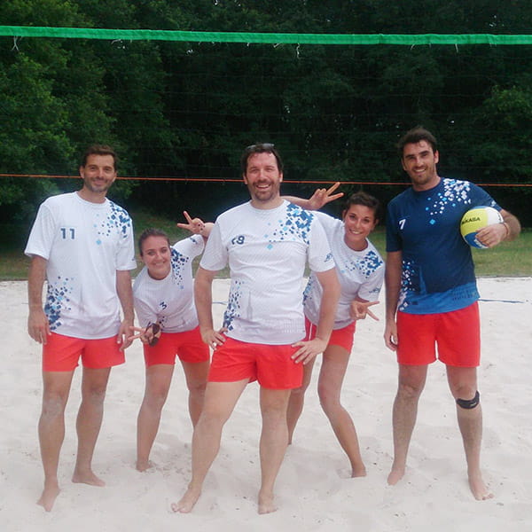 volleyball players wearing white shirts and red shorts