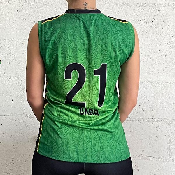 back of a woman wearing a green sublimated sleeveless jersey #21