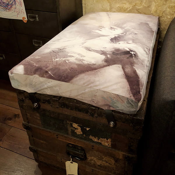 chest with white fabric covering
