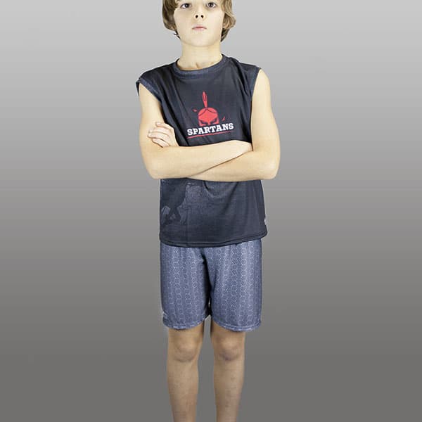 kid wearing grey shorts and black singlet arms crossed