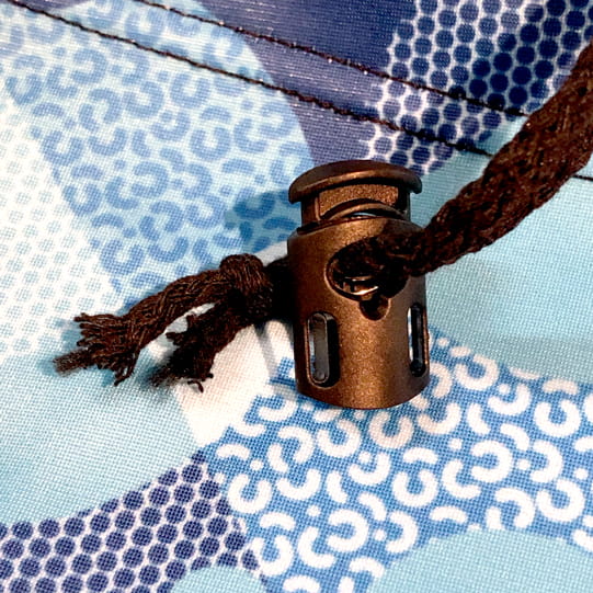 black spring lock toggle on blue printed fabric