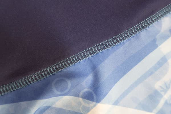 blue sublimated textile with light blue sewing stitches